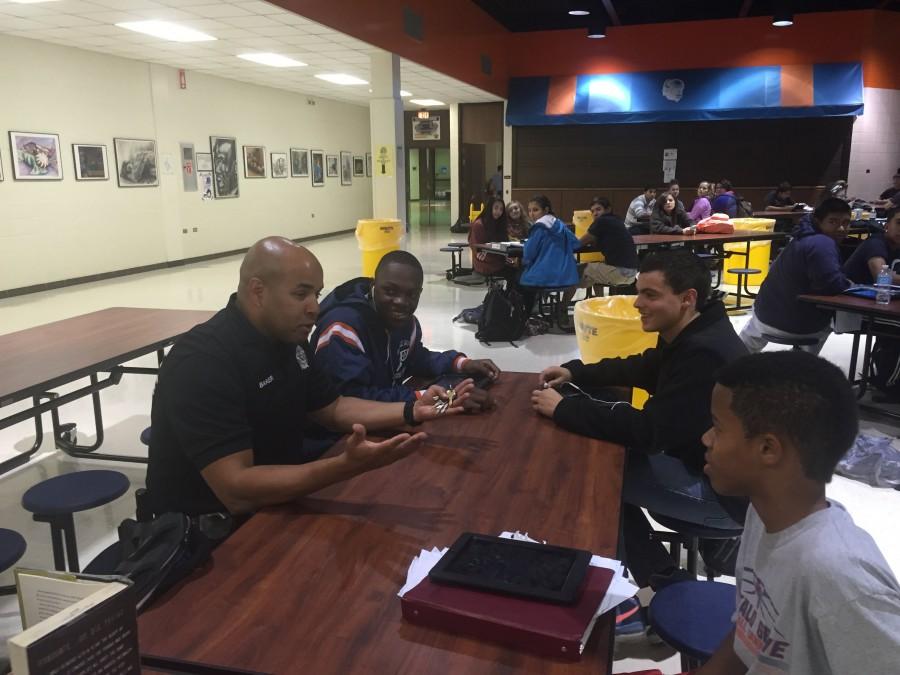 Officer Malcolm Baker interacts with a small group of students.