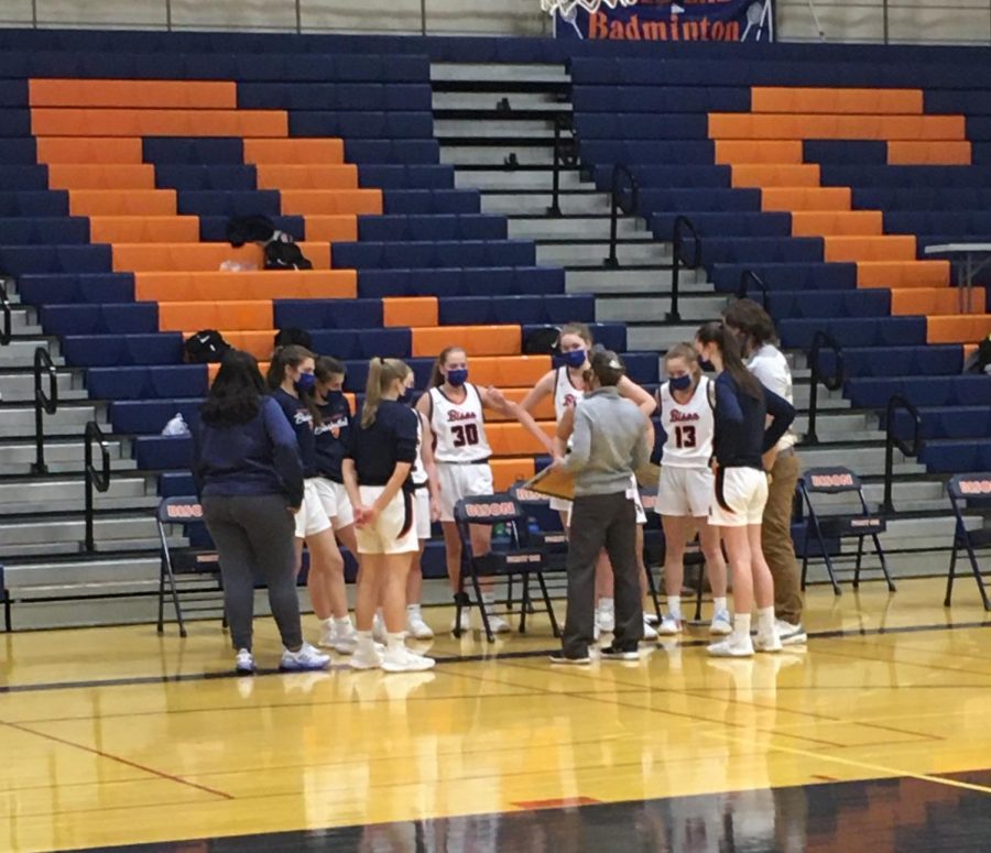 Bison varsity girls basketball takes a timeout during their Friday night game vs. EG to strategize. 