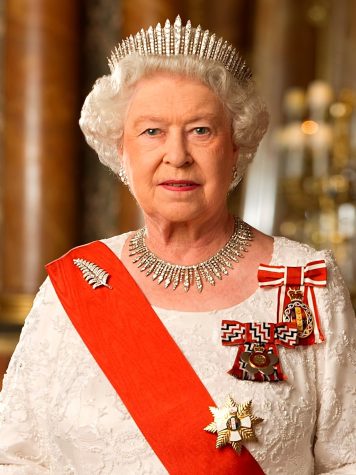 A LEGACY OF LEADERSHIP: Queen Elizabeth II poses for the camera adorned in various medallions and a red sash. 